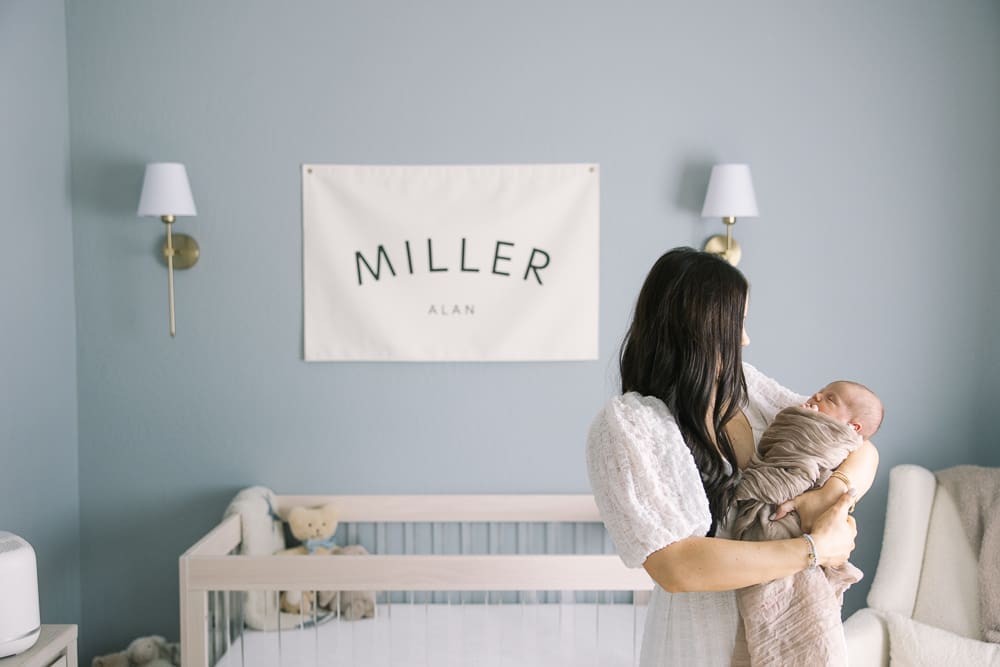 mom holding her newborn in the nursery