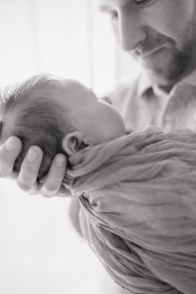 dad holding his newborn baby