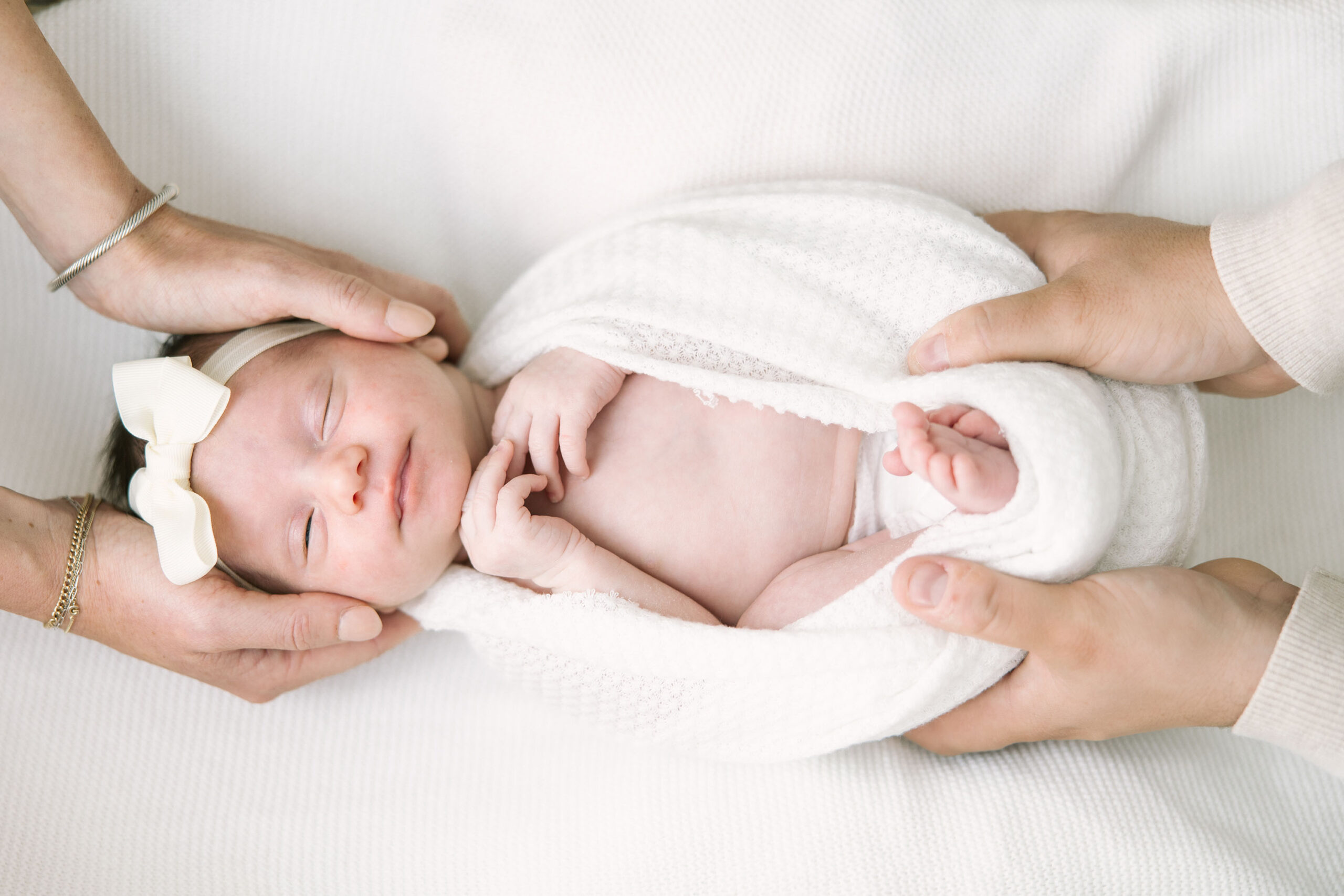 baby sleeping in dad's arms