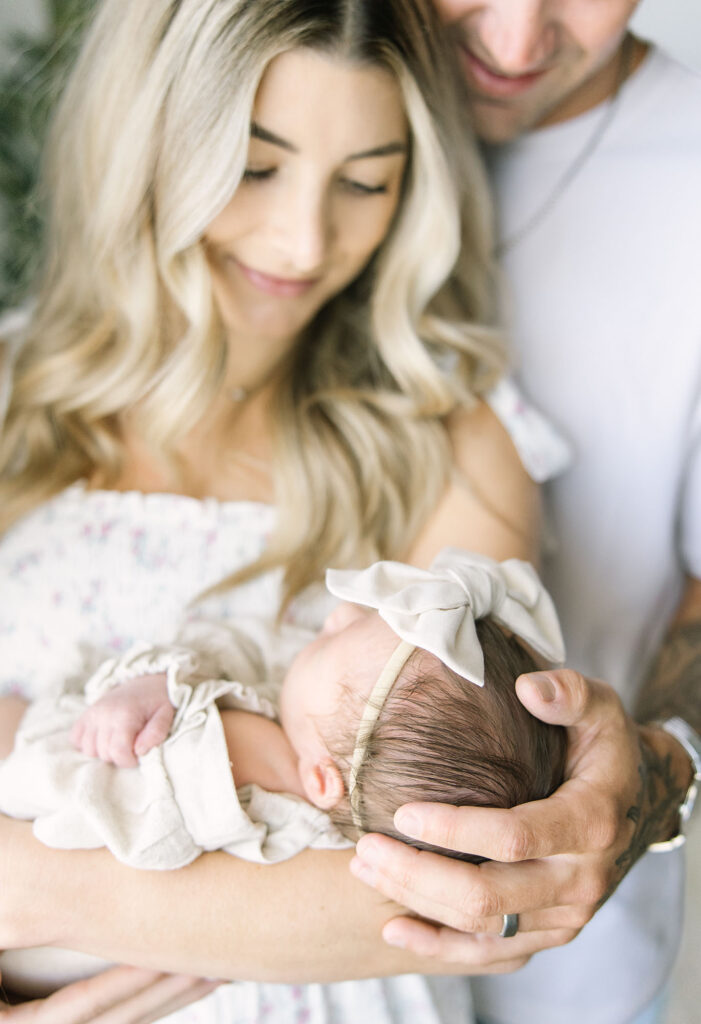 Couple cuddling their newborn baby